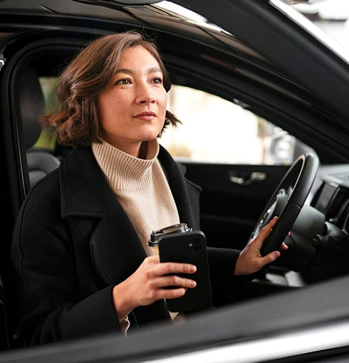 A right close up of a yellow Mercedes AMG sports car headlight on a city street