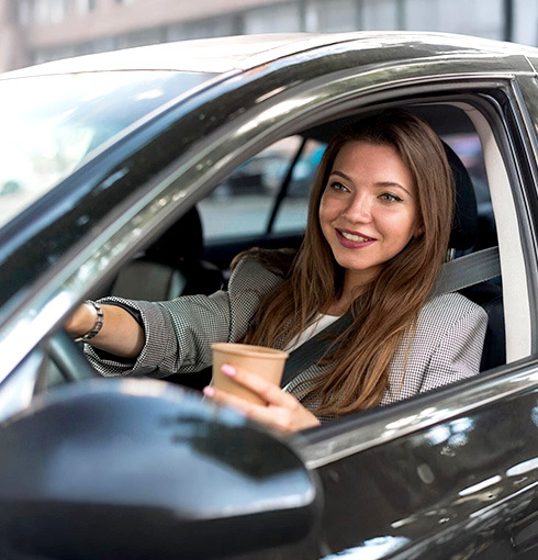 A right close up of a yellow Mercedes AMG sports car headlight on a city street