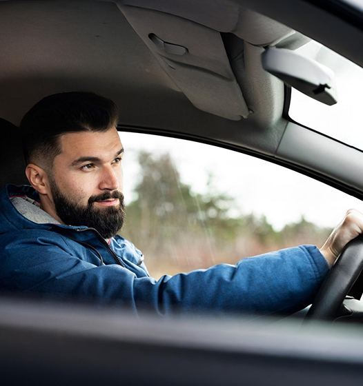 A right close up of a yellow Mercedes AMG sports car headlight on a city street