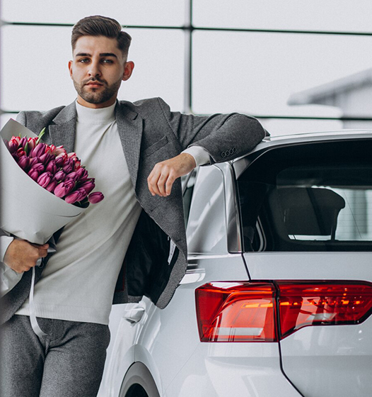 A right close up of a yellow Mercedes AMG sports car headlight on a city street