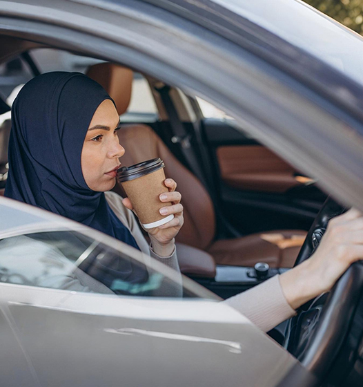A right close up of a yellow Mercedes AMG sports car headlight on a city street